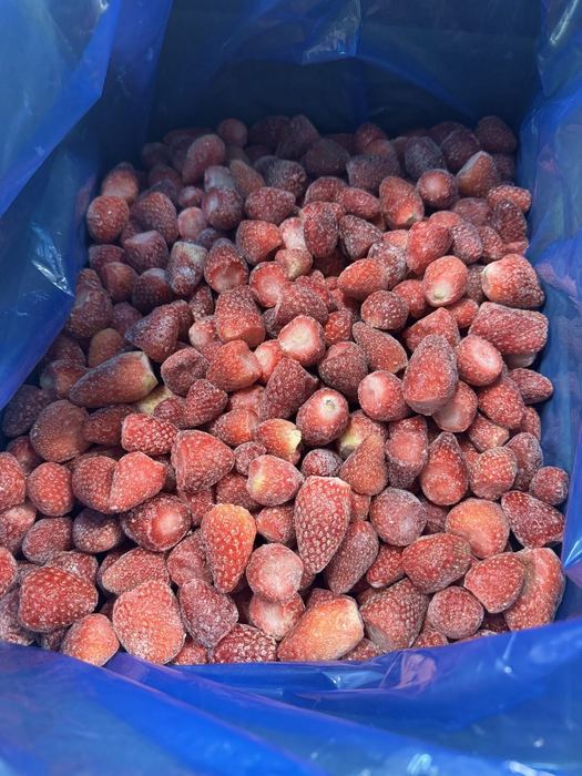 IQF frozen whole strawberries, free-flowing in a lined bulk carton