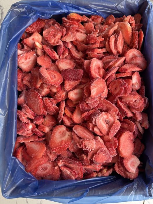 IQF frozen sliced strawberries in a lined bulk carton