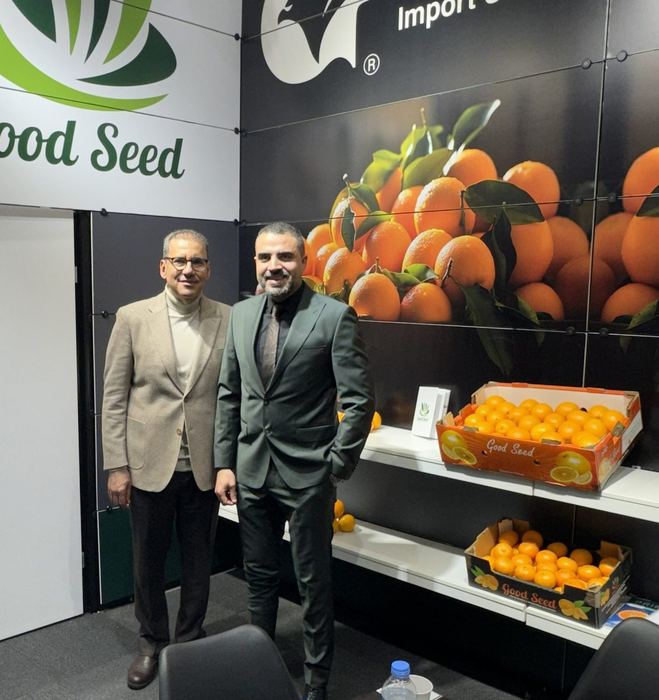 The Good Seed team at their stand with fresh Egyptian orange cartons on display