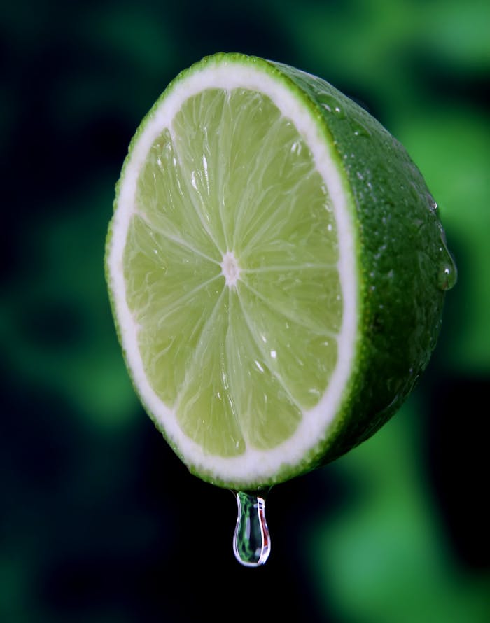 background-water-breakfast-bright-161573 Macro shot of a juicy, fresh lime slice with a water droplet, highlighting its vibrant green color.